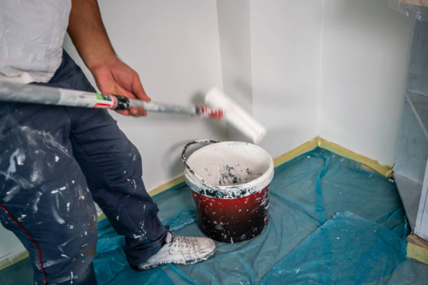 istock blue collar worker is painting wall with motion blur horizontal construction still 1715362241