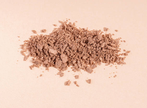 istock Makeup cosmetics. Eyeshadow or blush crushed palette, colorful eye shadow powder on beige background 1715385388