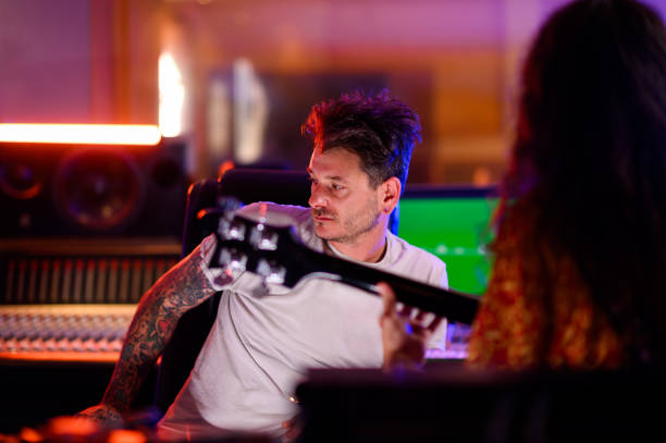 istock A studio recorder listening to a guitar player in a studio. 1715399258