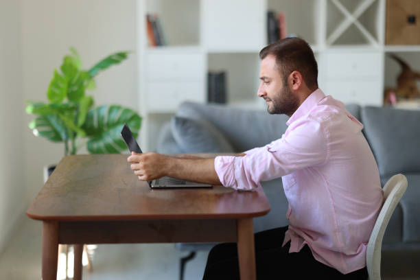 istock Serious male employee busy using modern laptop in office 1715403657