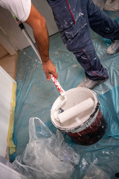 istock blue collar worker is painting wall vertical cropped construction still 1715408865