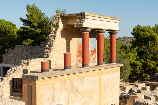 Knossos, Heraklion, Crete, Greece - September 21st 2023 - The reconstructed ruins of the west bastion of Knossos Palace in the morning sunlight.