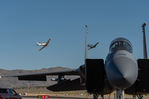 Team Race 90 flying past an F-15 in silver class T6 race at the Reno Air Races