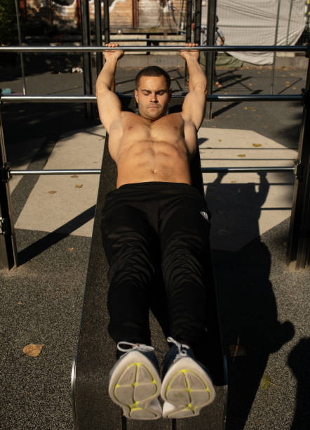 istock Man athlete trains abdominal muscles outdoor. 1715460531
