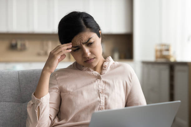 istock Concerned tired Indian remote employee woman using laptop 1715467818