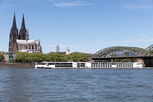 Cologne, Germany - May 5, 2018: river cruise ship Viking Vidar passing Cologne Cathedral