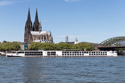 Cologne, Germany - May 5, 2018: river cruise ship Viking Vidar passing Cologne Cathedral