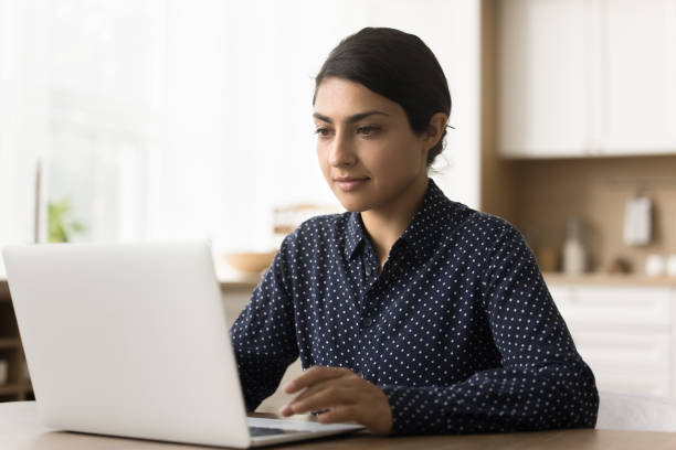 istock Focused adult Indian student studying online at home 1715485871