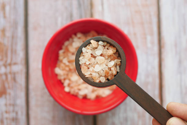 istock Raw dried pink Himalayan salt in a wooden spoon 1715504572