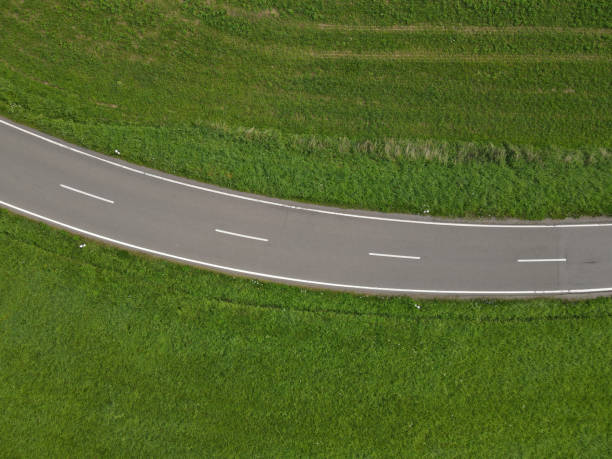 istock Asphalt road between grass in the landscape 1715505145