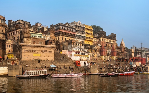 Varanasi, India, November 23, 2015: The Hindus perform a morning ritual bath in the sacred Ganges River in the holy city of Varanasi. These ritual baths should purify the soul and body. Also, ashes from bodies of deceased people are poured into the Ganges, hoping to be freed from samsara.