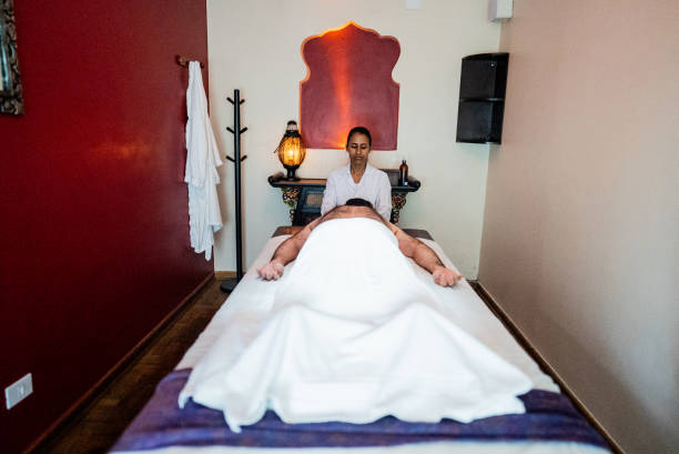 Therapist massaging a man at a spa