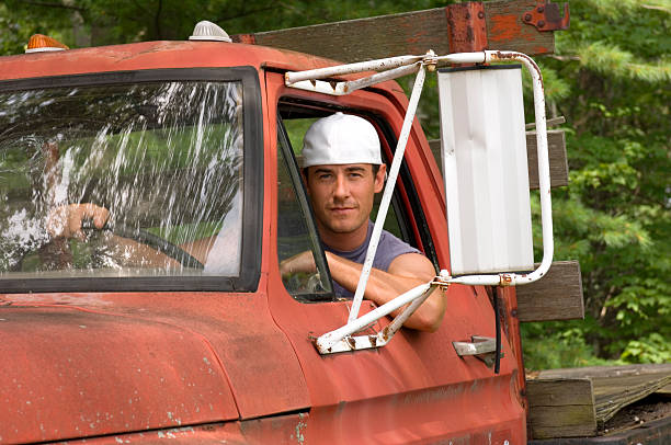 Handsome Young Man in Truck This good-looking young man drives a beat-up old truck. He\'s wearing a white ballcap (backwards). noah young stock pictures, royalty-free photos & images