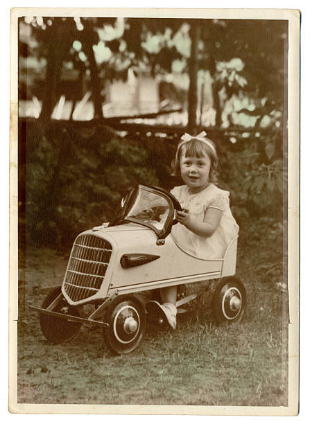 Old family photo of my grandmother in a toy car.