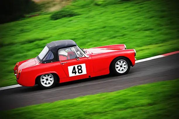 60s roadster racing round a track.