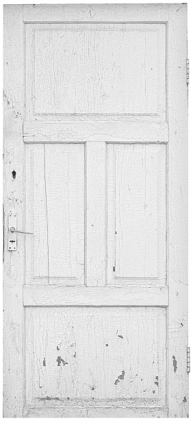 Old shabby white textured wooden door is isolated.