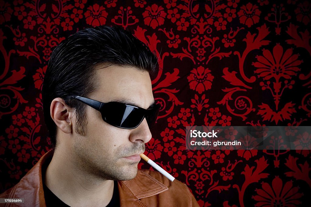 Cool guy Tough guy with leather jacket and cigarette in mouth.Similar from my portfolio: Adult Stock Photo