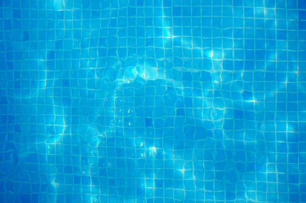 Blue pool bottom with sun highlights stock photo