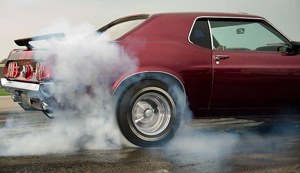 Burning Rubber! Car warming up tires before drag race. car burnout stock pictures, royalty-free photos & images