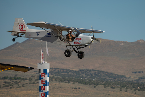 An airplane passes the home pylon during the STOL (Short Take Off and Landing) drag racing competitions at the Reno Stead airport