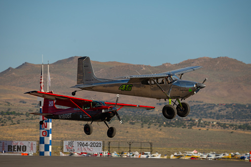 Two airplanes pass the home pylon during the STOL (Short Take Off and Landing) drag racing competitions at the Reno Stead airport