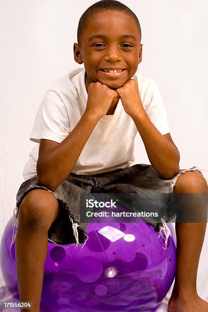 Smiling Boy On Purple Ball Stock Photo - Download Image Now - Adult, African Ethnicity, African-American Ethnicity