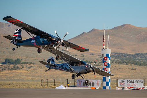 Two airplanes pass the home pylon during the STOL (Short Take Off and Landing) drag racing competitions at the Reno Stead airport