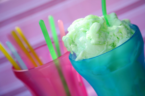 apple flavoured gelato in blue glass against pink