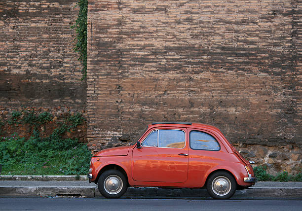 istock Tiny Italian car in front of Rome's city wall. 171557479