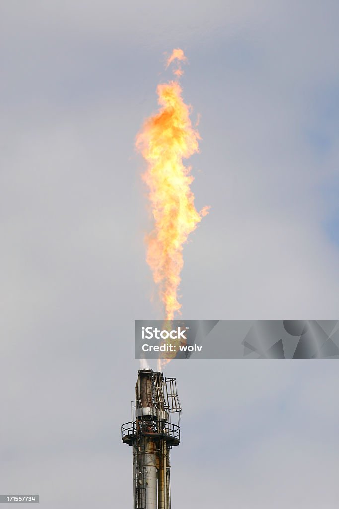 Industrial 8 with fire coming out Flare stack at a refinery. Flare Stack Stock Photo