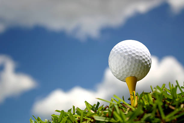 Golf Ball with Puffy Clouds stock photo