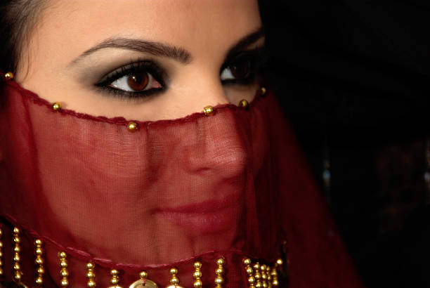 Exotic Women An exotic woman looking from beneathe her veil noah young stock pictures, royalty-free photos & images