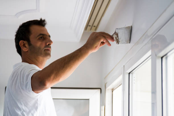 istock Painter Painting The Upside Of Window With Brush 1715594471