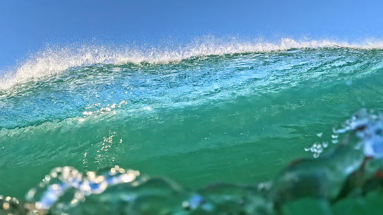 Photograph of a wave about to hit the waterproof camera on a sunny day