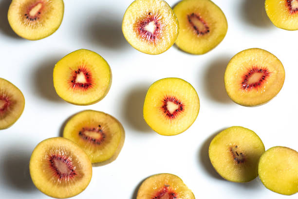 Many slices of red kiwi fruit isolated on white