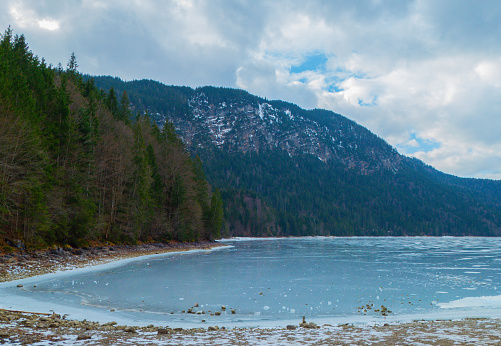 Landscape of frozen Longemer lake in the Vosges Mountain, France