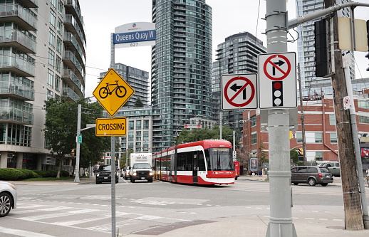 Toronto, Canada - August 25, 2023: The TTC 509 Harbourfront street heads east on Queen Quay West to the Harbourfront-CityPlace neighborhood by Lake Ontario. Summer morning with overcast skies.