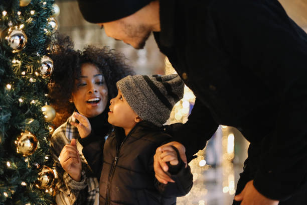 Mom and dad take baby boy for Christmas shopping in NY