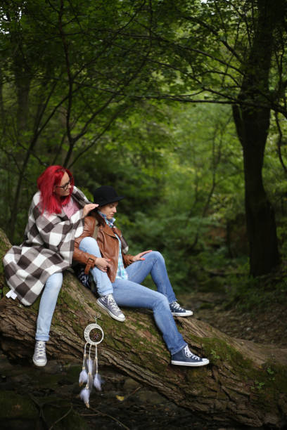 two girls in beautiful points, sweaters and skirts in the wood