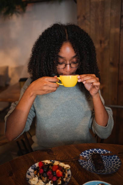 istock Young woman having a coffee in a cafeteria. She is having brunch 1715672012