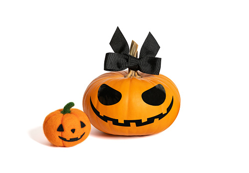 Halloween pumpkin girl with little wool pumpkin. Jack o Lantern Lady pumpkin with a black bow isolated on a white background.