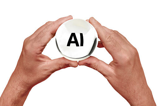 holding crystal ball with AI visible, indicating artificial intelligence as the future