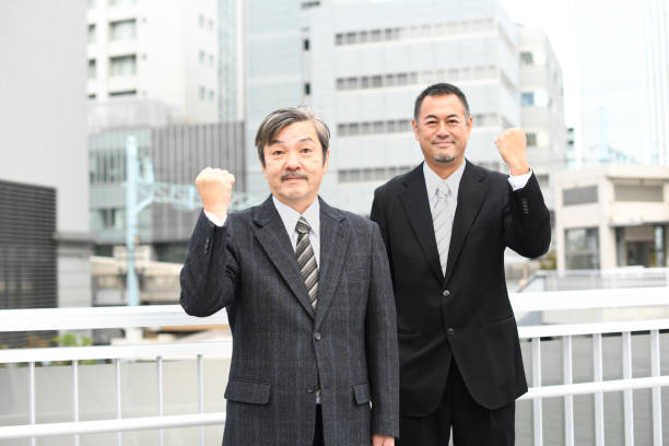 istock Middle-aged and elderly businessmen doing a fist pump 1715705426