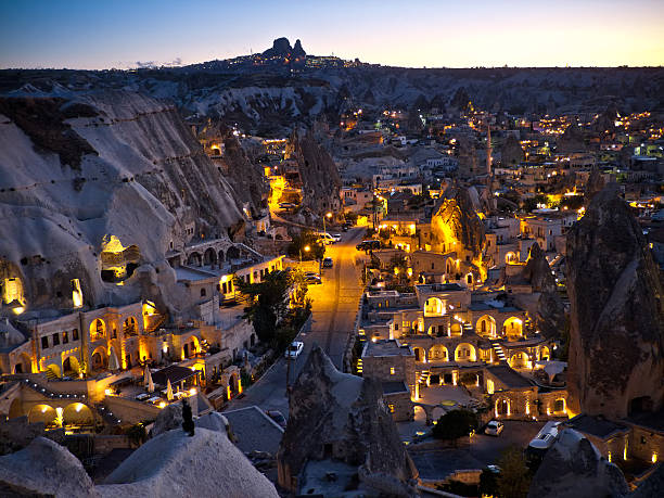 Göreme, Cappadocia in the Evening A view from above GAreme, Cappadocia, Turkey in the evening. GAreme is the touristical center of the GAreme National Park, added to the World Heritage List in 1985. A lot of homes and so called "cave hotels" have been carved straight into the rock formations (fairy chimneys) of the town. On the horizon the town Uchisar and its castle rock can be seen. rock hoodoo stock pictures, royalty-free photos & images