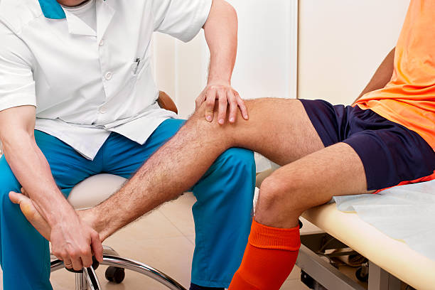 istock Doctor testing injured football player 171571140
