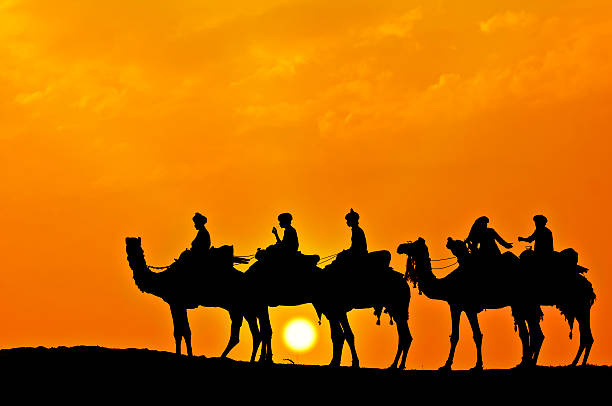istock Silhouette of Camel Caravan in the Desert at Sunset (XVI) 171571203