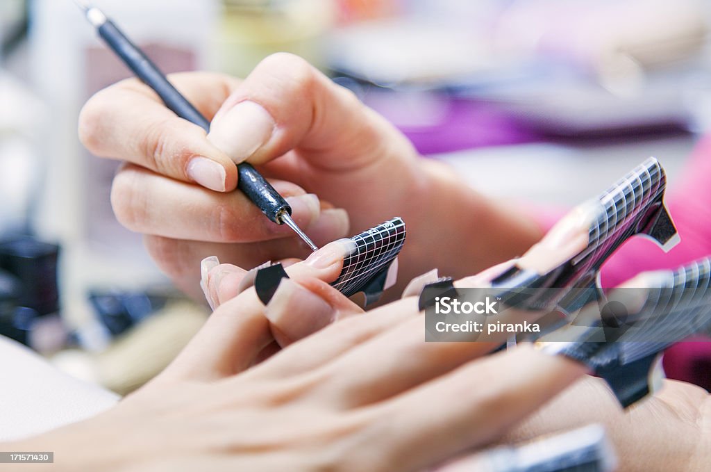 Nail manicure - gel nails Beautician applying gel on fingernails Artificial Nail Stock Photo