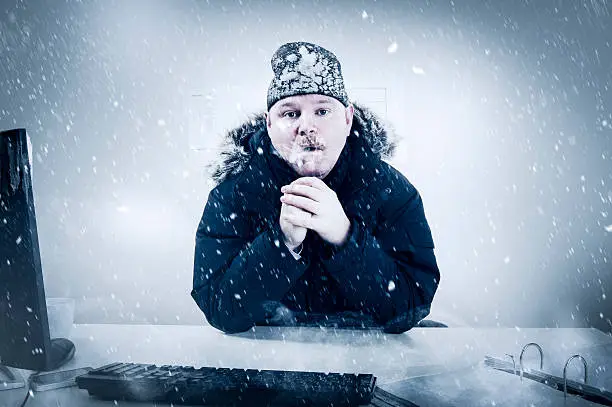 Photo of Businessman in a Cold Office with Snow and Ice