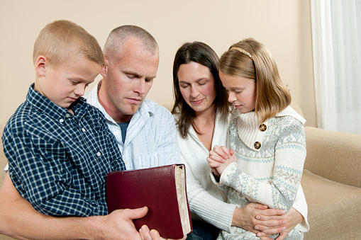 A family praying together - Buy credits