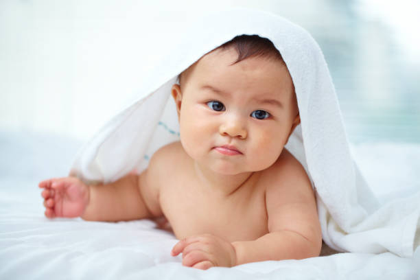 istock lovely baby boy in bed 171571720